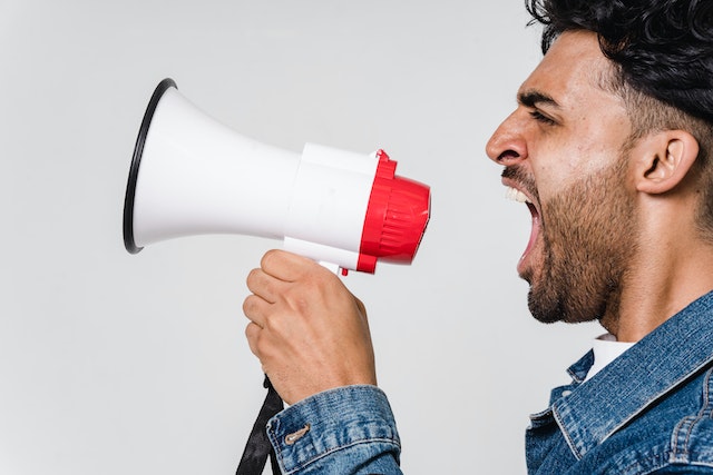pexels-sora-shimazaki-5935755 person screaming into megaphone